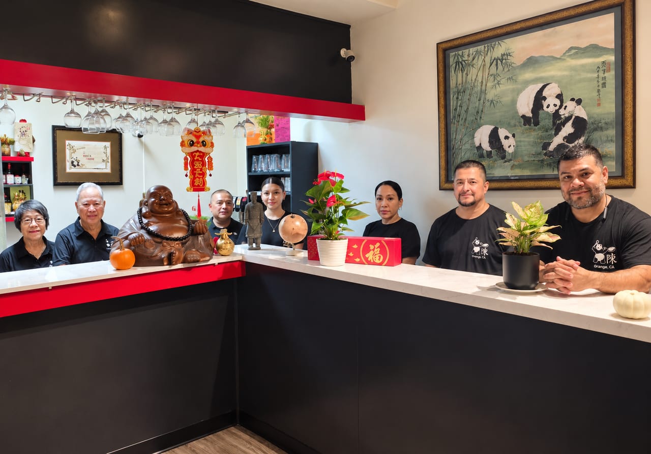 The Chen's Chinese Kitchen team standing together behind the restaurant's front counter